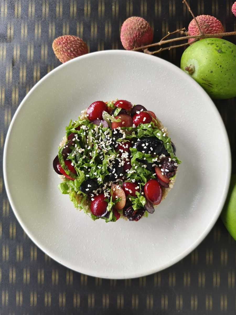A plated dish garnished with herbs and pomegranate