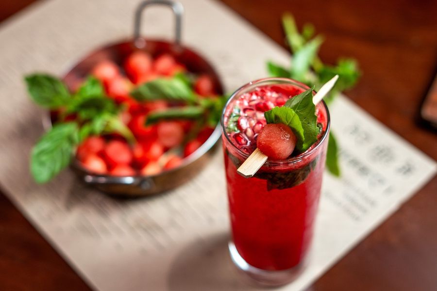 Two coolers served with fresh berries and mint