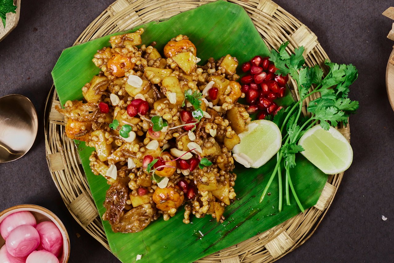 A colourful vegetarian dish served on a banana leaf in a woven basket